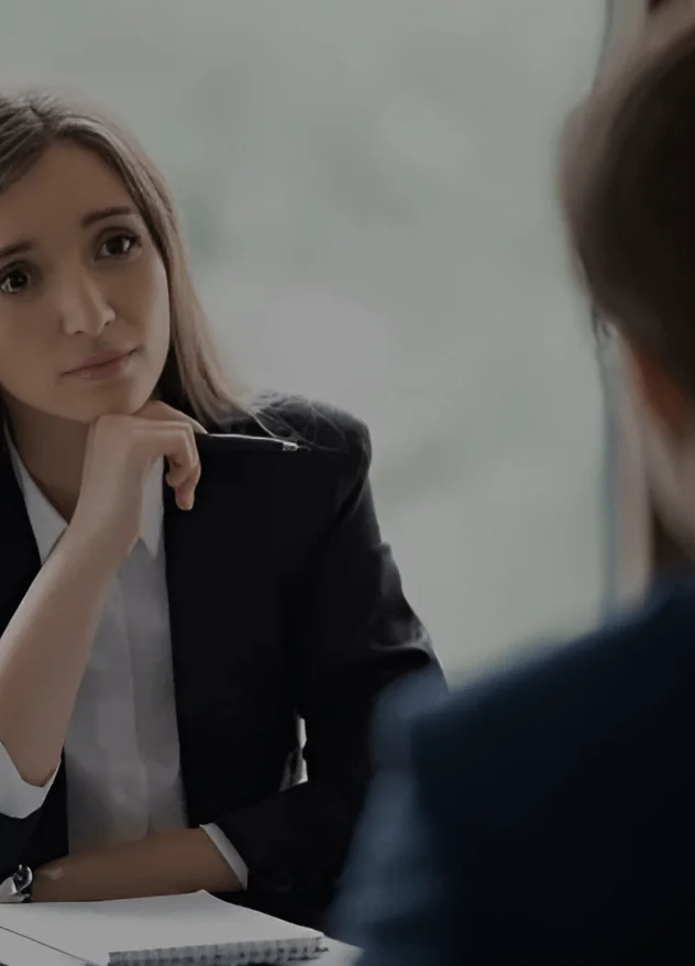 A sympathetic looking sexual abuse lawyer listens to a client tell the details of their case in her Chicago office.