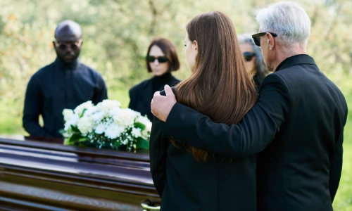 People mourning at a wrongful death victim's funeral.